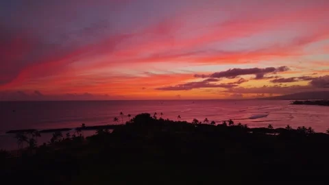 Dramatic crimson sunset over Magic Island lagoon and ocean in Honolulu 2 Stock Footage 346427902
