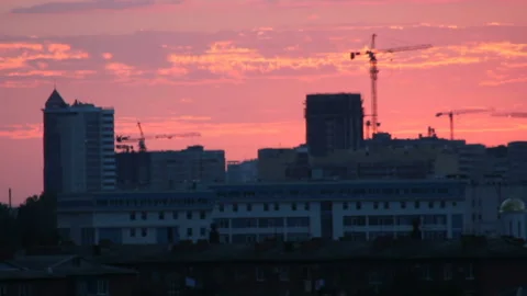 Dramatic crimson twilight over town Stock Footage 99623124