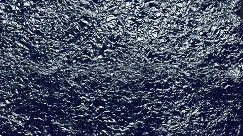 Dramatic crumpled aluminum foil macro texture with intricate metallic folds.. Stock Photos