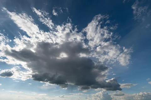 Dramatic cumulus cloud against blue sky with sunlight Stock Photos