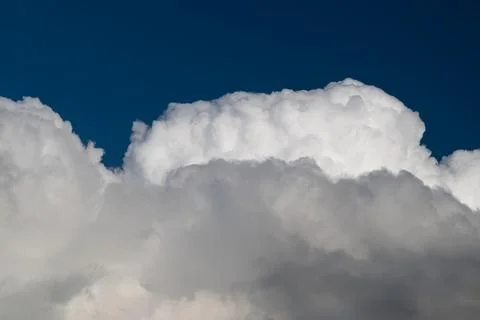 Dramatic cumulus cloud against indigo sky, high contrast edges and deep sha.. Stock Photos