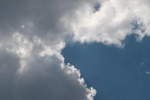 Dramatic cumulus cloud edge against blue sky with sunlight rim 写真素材