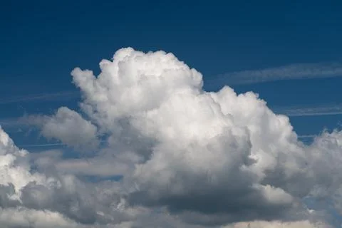 Dramatic cumulus cloud formation against a deep blue sky Stock Photos