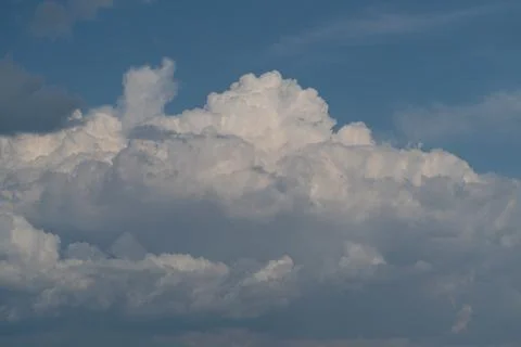 Dramatic cumulus cloud formation against blue sky Stock Photos