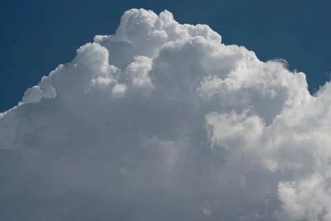 Dramatic cumulus cloud formation against deep blue sky Stock Photos