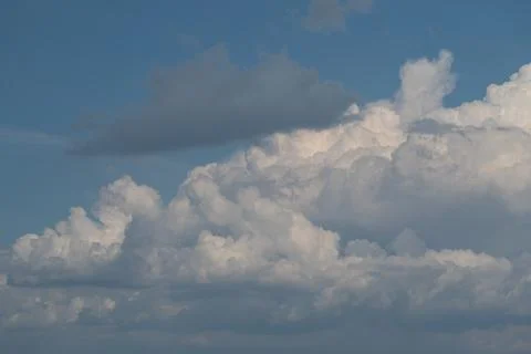 Dramatic cumulus cloud formation against blue sky 写真素材