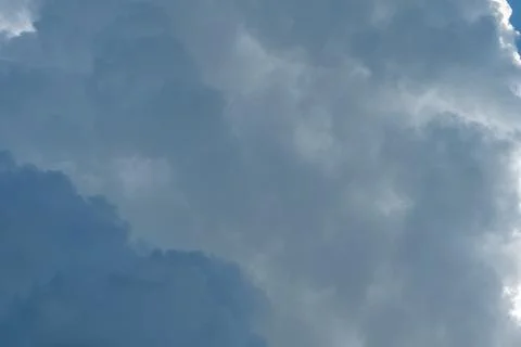 Dramatic cumulus cloud formation with soft sunlight and deep blue sky creat.. Stock Photos