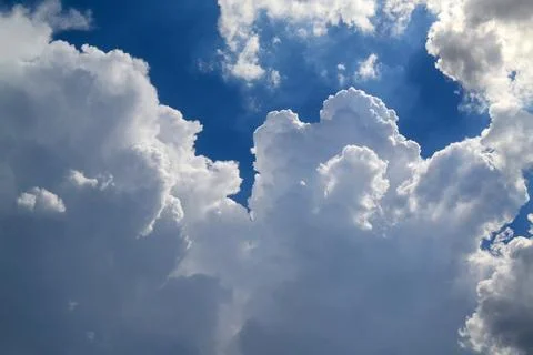 Dramatic cumulus clouds against blue sky Stock Photos
