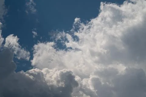 Dramatic cumulus clouds against blue sky Stock Photos