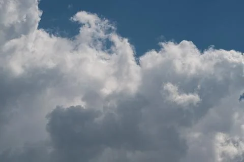 Dramatic cumulus clouds against blue sky Stock Photos