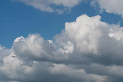 Dramatic cumulus clouds against a bright blue sky Stock Photos