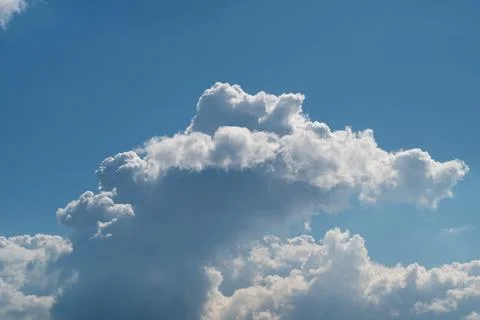 Dramatic cumulus clouds against a clear blue sky Stock Photos