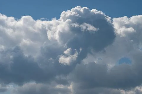 Dramatic cumulus clouds against a clear blue sky Stock Photos
