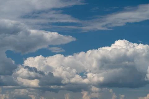 Dramatic cumulus clouds against a deep blue sky Stock Photos