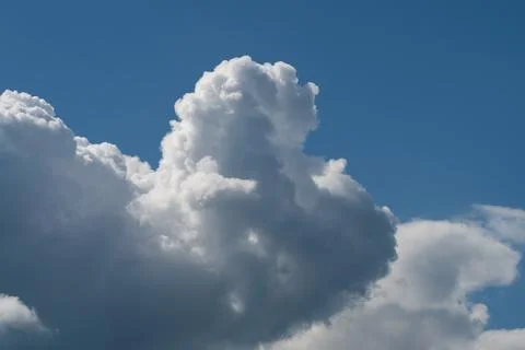 Dramatic cumulus clouds against deep blue sky Photos