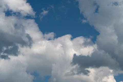 Dramatic cumulus clouds against deep blue sky Stock Photos