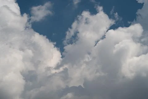 Dramatic cumulus clouds against deep blue sky Photos