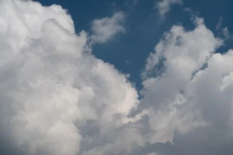 Dramatic cumulus clouds against deep blue sky Stock Photos