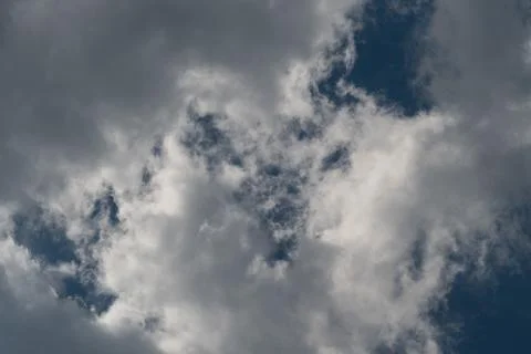 Dramatic cumulus clouds against deep blue sky Stock Photos