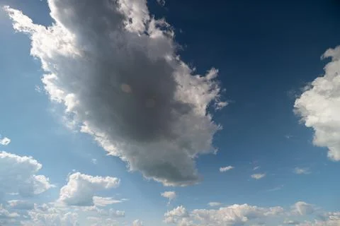 Dramatic cumulus clouds against deep blue sky Stock Photos