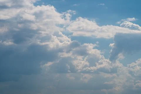 Dramatic cumulus clouds against a soft blue sky Stock Photos