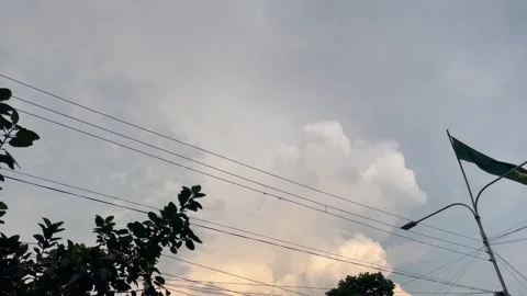 Dramatic Cumulus Clouds and Stormy Sky with Power Lines and Flag Stock-Footage 345668985