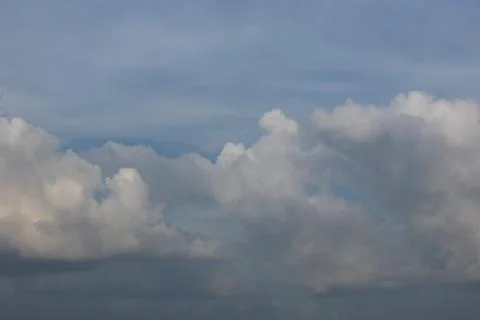Dramatic cumulus clouds in a blue sky before a storm Photos