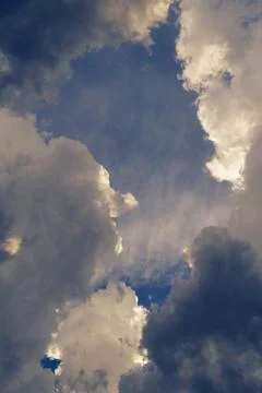 Dramatic cumulus clouds breaking apart after a violent thunderstorm Stock Photos