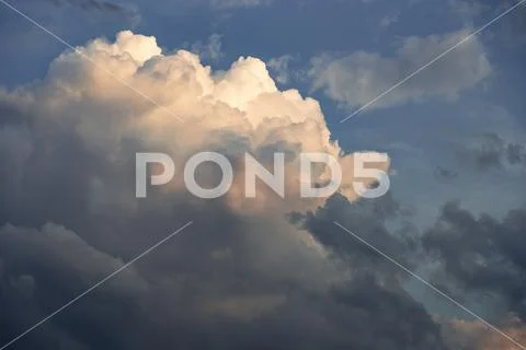 Dramatic cumulus clouds catching the sunlight Stock Photos