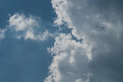 Dramatic cumulus clouds crossing blue sky Stock Photos