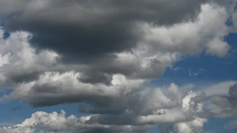 Dramatic cumulus clouds fill the sky, suggesting an approaching weather change Stock Footage 338381639
