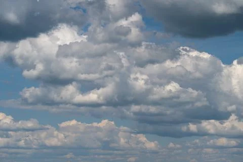 Dramatic cumulus clouds filling a blue sky with layered cloudscapes Stock Photos