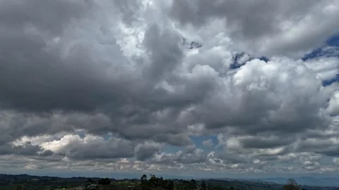 Dramatic cumulus clouds over lush landscape Stock Footage 316283561