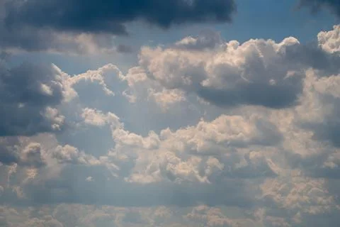 Dramatic cumulus clouds with sun rays breaking through Photos