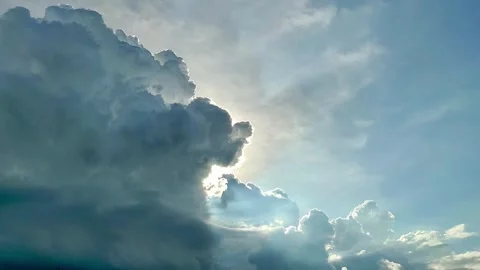 Dramatic Cumulus Clouds with Sunbeams and Blue Sky Stock Footage 346384533