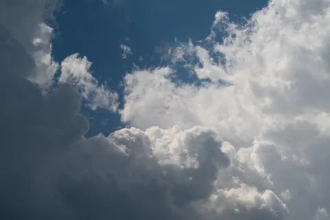 Dramatic cumulus clouds with sunlight breaking through a blue sky Photos