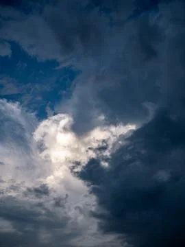Dramatic Cumulus Clouds with Sunlight Breaking Through Blue Sky Stock Photos