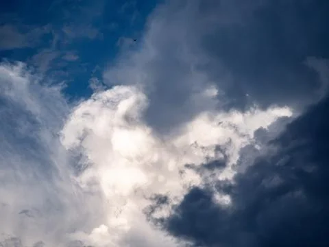 Dramatic Cumulus Clouds with Sunlight Breaking Through Blue Sky Stock Photos