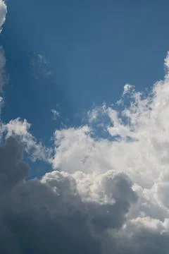 Dramatic cumulus clouds under bright blue sky Stock Photos