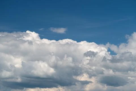 Dramatic cumulus cloudscape against deep blue sky Stock Photos