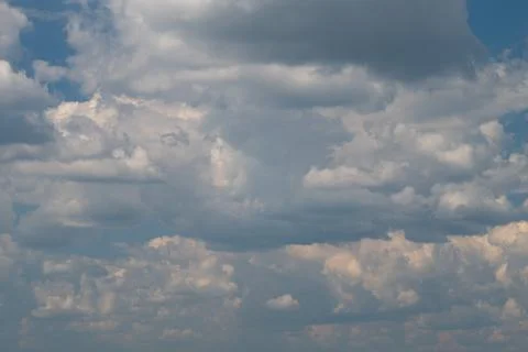 Dramatic cumulus cloudscape with layered sky and soft sunlight Stockfoto's