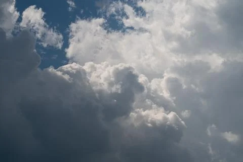 Dramatic cumulus cloudscape with sunlight and deep blue sky Stock Photos