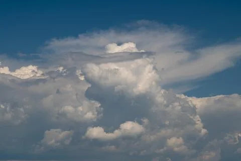 Dramatic cumulus cloudscape under deep blue sky Photos