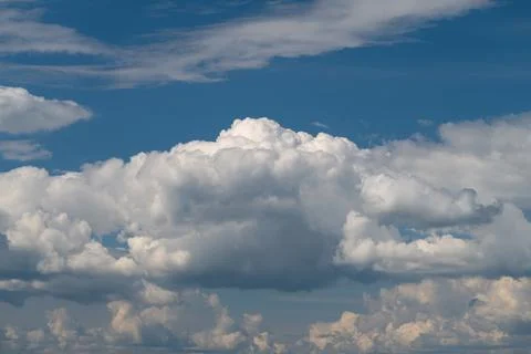Dramatic cumulus cloudscape under deep blue sky Stock Photos