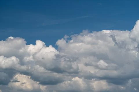 Dramatic cumulus cloudscape under deep blue sky Stock Photos