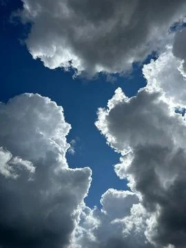 Dramatic Cumulus Storm Clouds Framing Deep Blue Sky Background Stock Photos