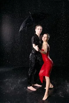 Dramatic Dance Couple Portrait with Umbrella Looking at Camera Stock Photos