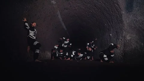 Dramatic Dance Performance in a Dark Tunnel Stock Footage 296687923