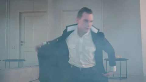 Dramatic Dancer Lying on Ground in Smoke Filled Studio Stock Footage 308665161