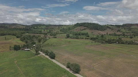 Dramatic Dark Aerial of Green Rolling Hills, Farm Huts and Brooding Storm C.. Stock-Footage 337529661